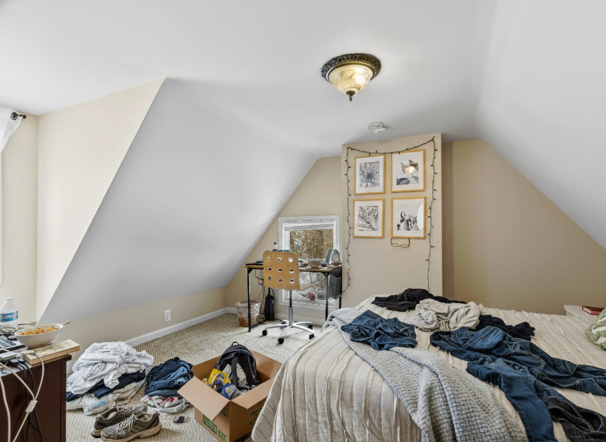 Bedroom before preparation - cluttered with personal items